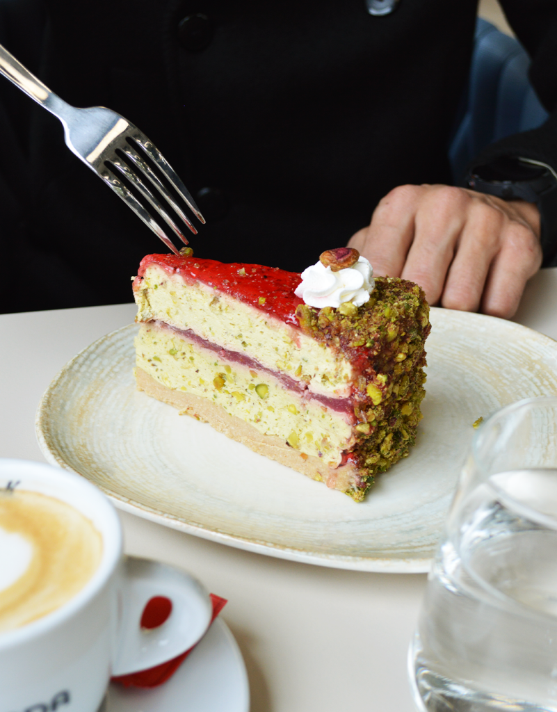 Pistachio cheesecake with raspberry sauce at Serenada Bistro Dubrovnik creamy dessert with fresh berries topping.